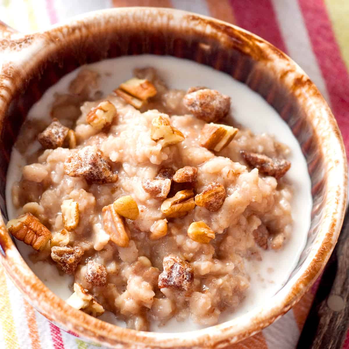 A serving of date nut oatmeal in a brown bowl.