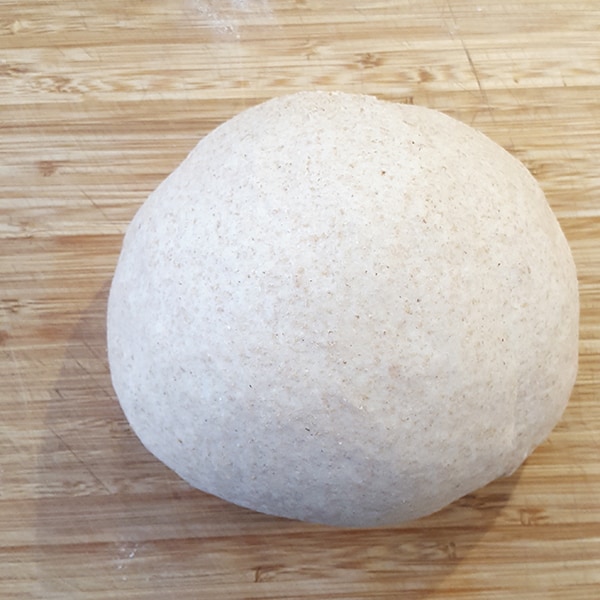 Dough on a board after lightly kneading.