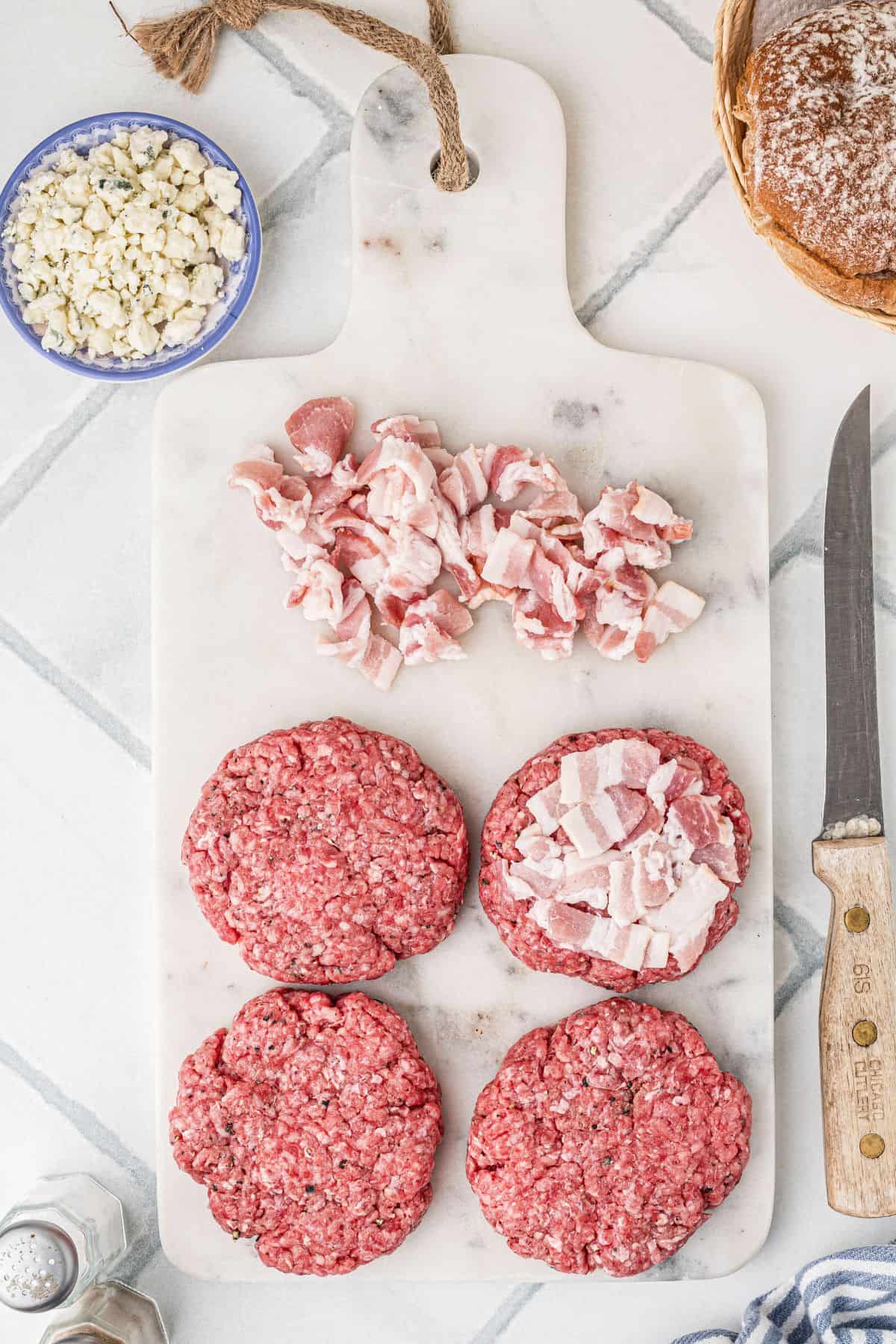 Some of the chopped bacon pressed lightly into the top of a ground beef patty.