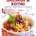 Bowl of rotini pasta with sausage, olives, tomato sauce, and basil, on a striped towel.