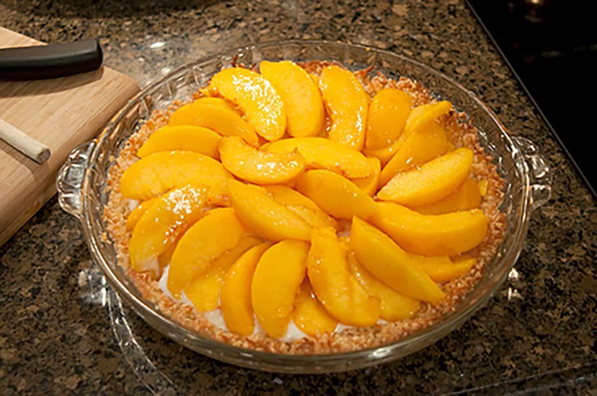 Sliced peaches added on top of pie filling.
