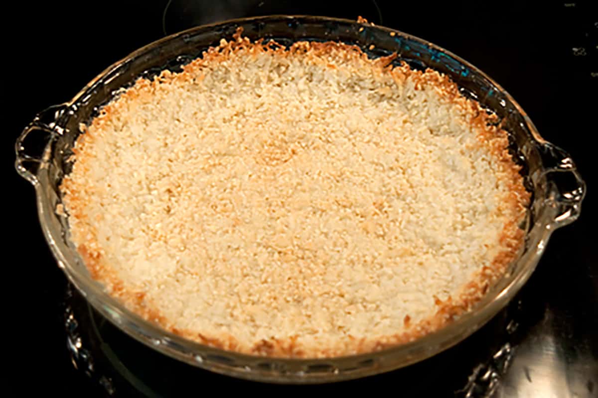 Baked pie crust in a glass dish.