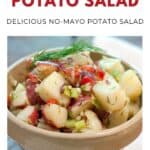 Bowl of lemon dill potato salad with herbs and chopped vegetables, labeled as a no-mayo potato salad.