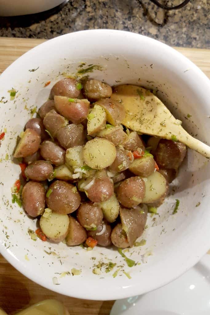 Toss potatoes with dressing