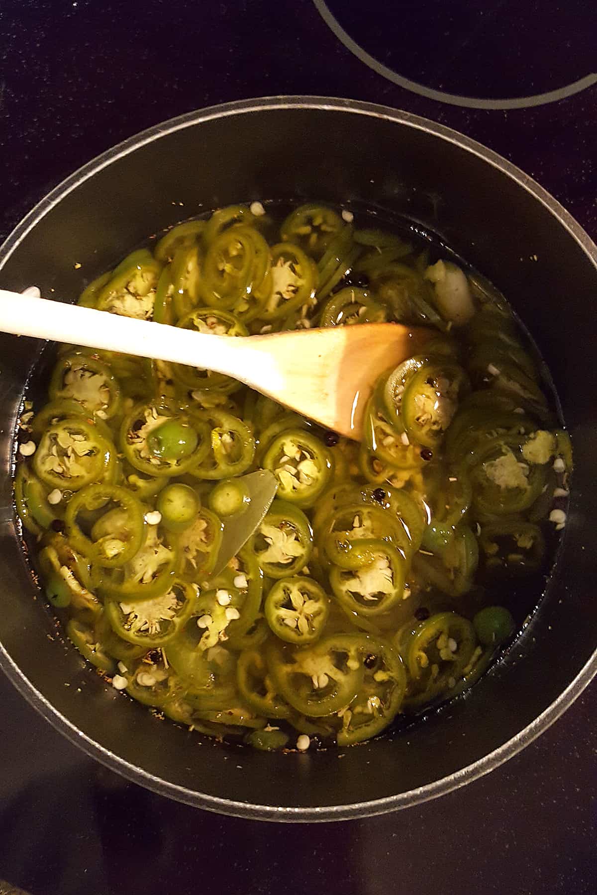 Photo showing jalapeno slices changed in color from bright green to olive green.