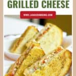 Two halves of a caprese grilled cheese sandwich with melted cheese and tomatoes on crusty bread.