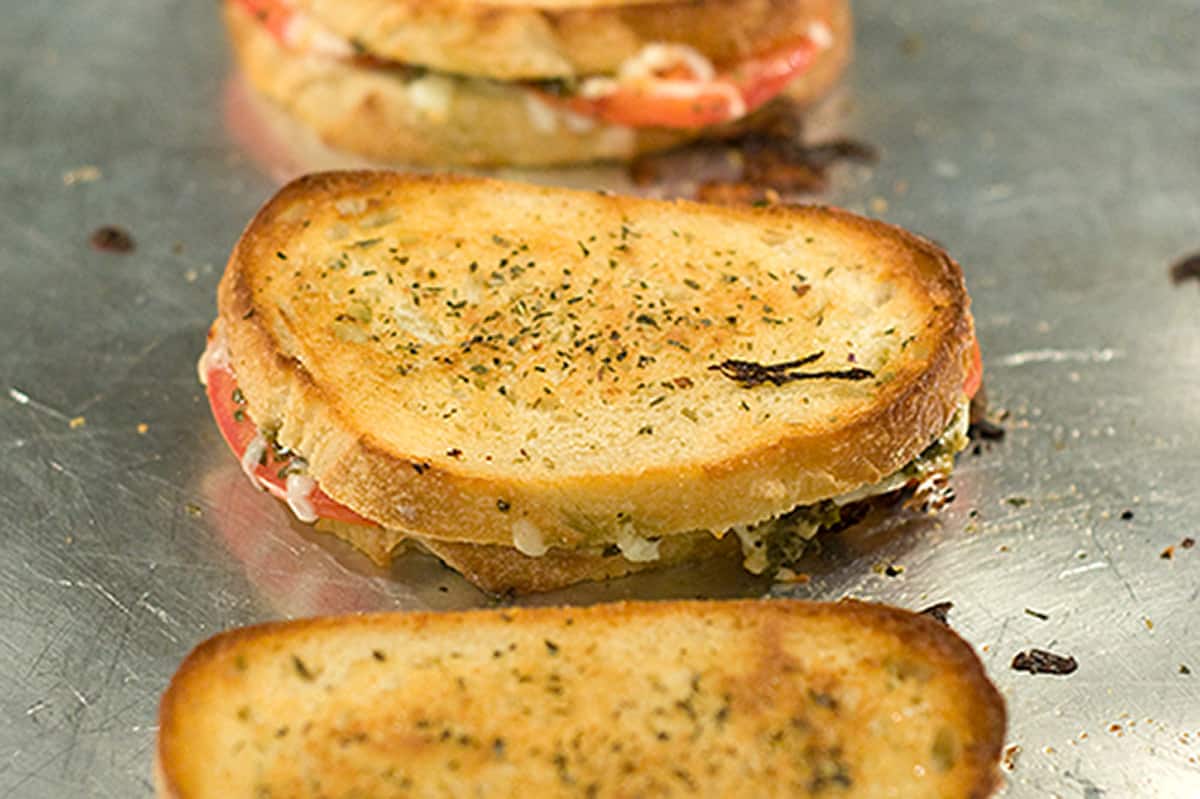 Toasted sandwiches on a baking sheet.