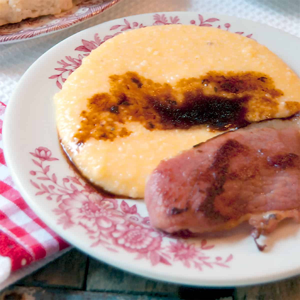 Country Ham with Red Eye Gravy - Salty, dry cured country ham with red eye gravy flavored with strong black coffee served with a side of cheese grits. https://www.lanascooking.com/country-ham-with-red-eye-gravy/