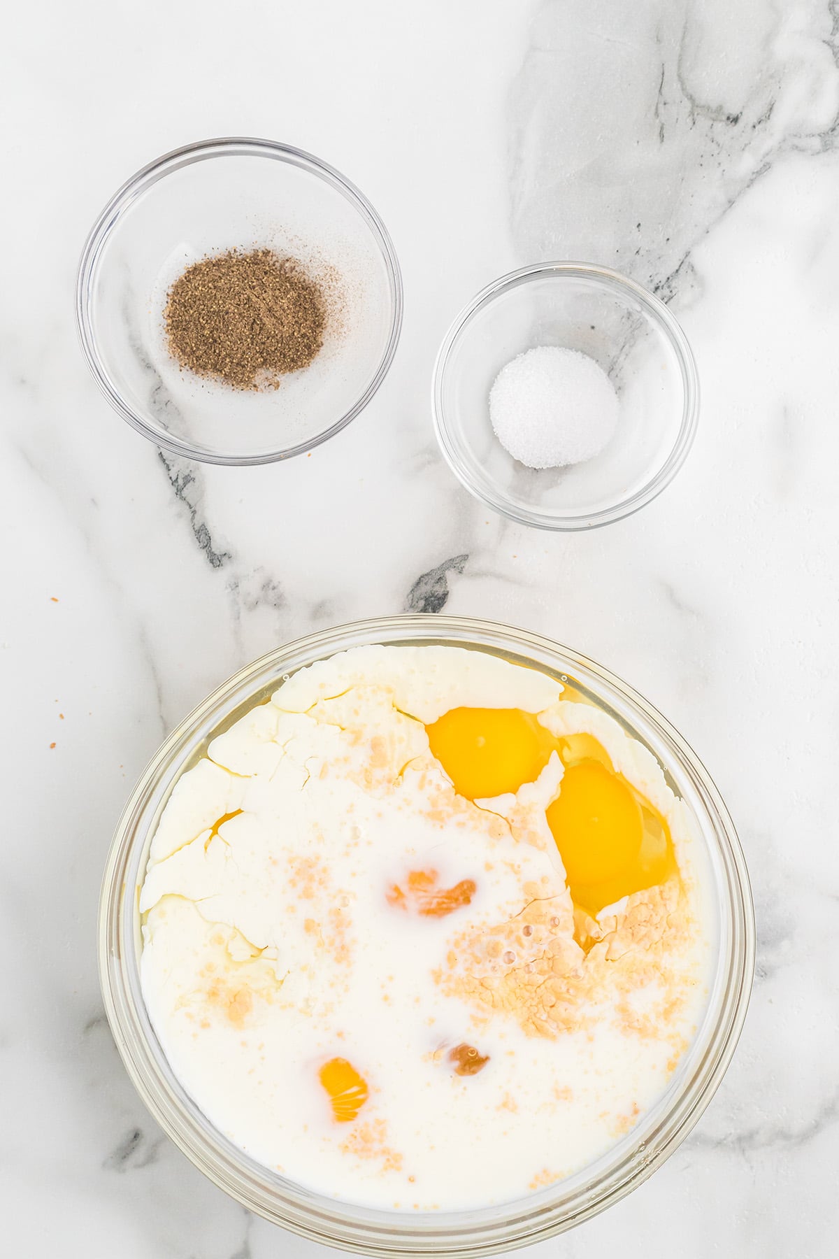 Eggs, milk, and seasonings in a bowl.