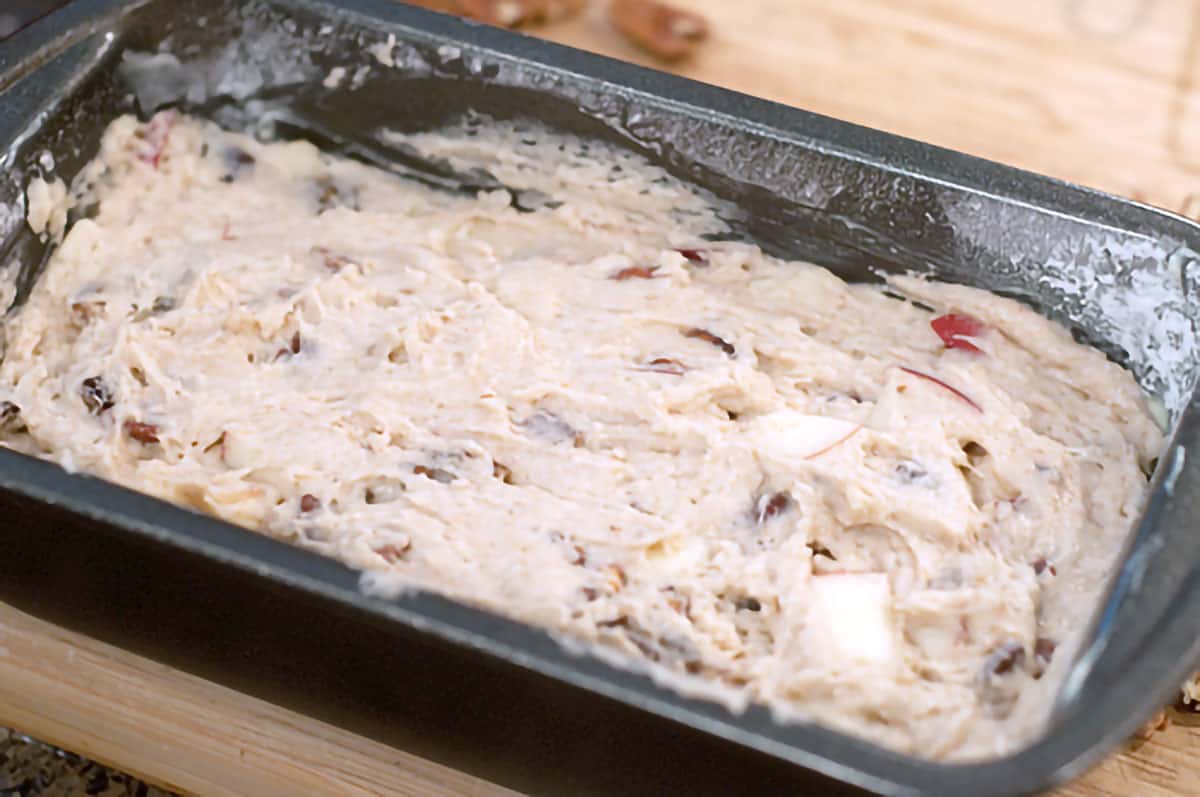 Apple bread batter in a loaf pan.