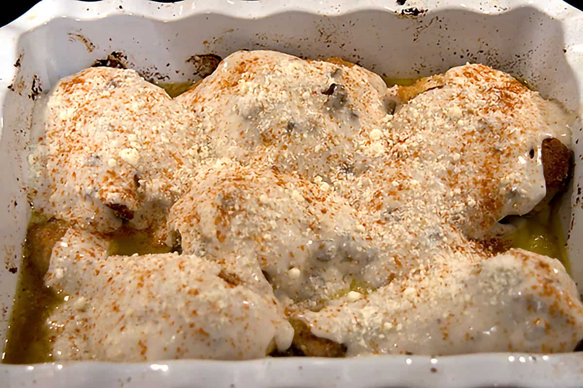 Sauce mixture poured over chicken in the baking dish.
