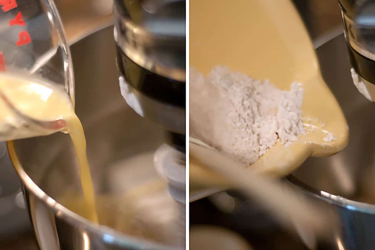 Wet and dry ingredients being added alternately to creamed butter and sugar in a stand mixer.