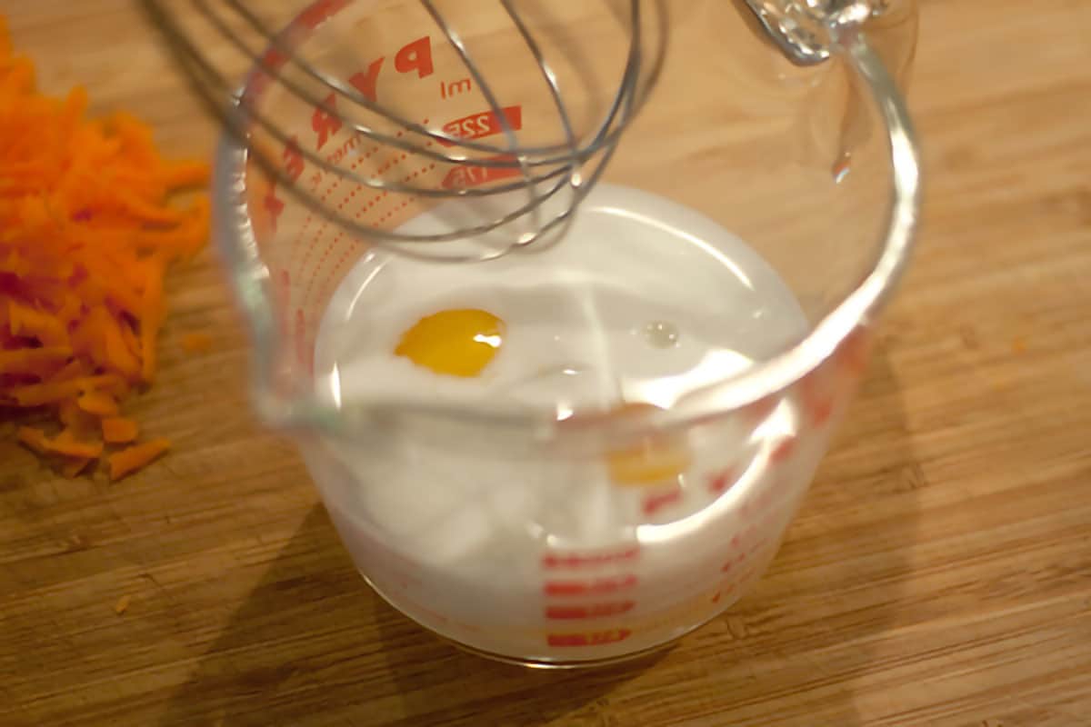 Eggs and milk in a 4-cup measuring cup.