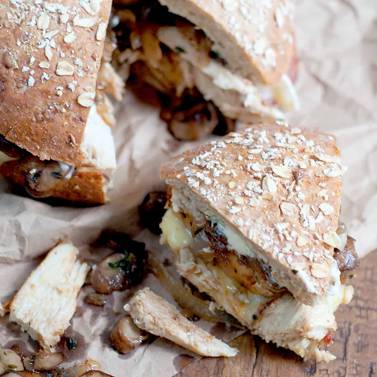 Chicken, Bacon, and Mushroom Sandwich on a whole grain boule, with garlic mayonnaise and layered with bacon, brie, caramelized onions, and mushrooms. https://www.lanascooking.com/chicken-bacon-mushroom-sandwich/