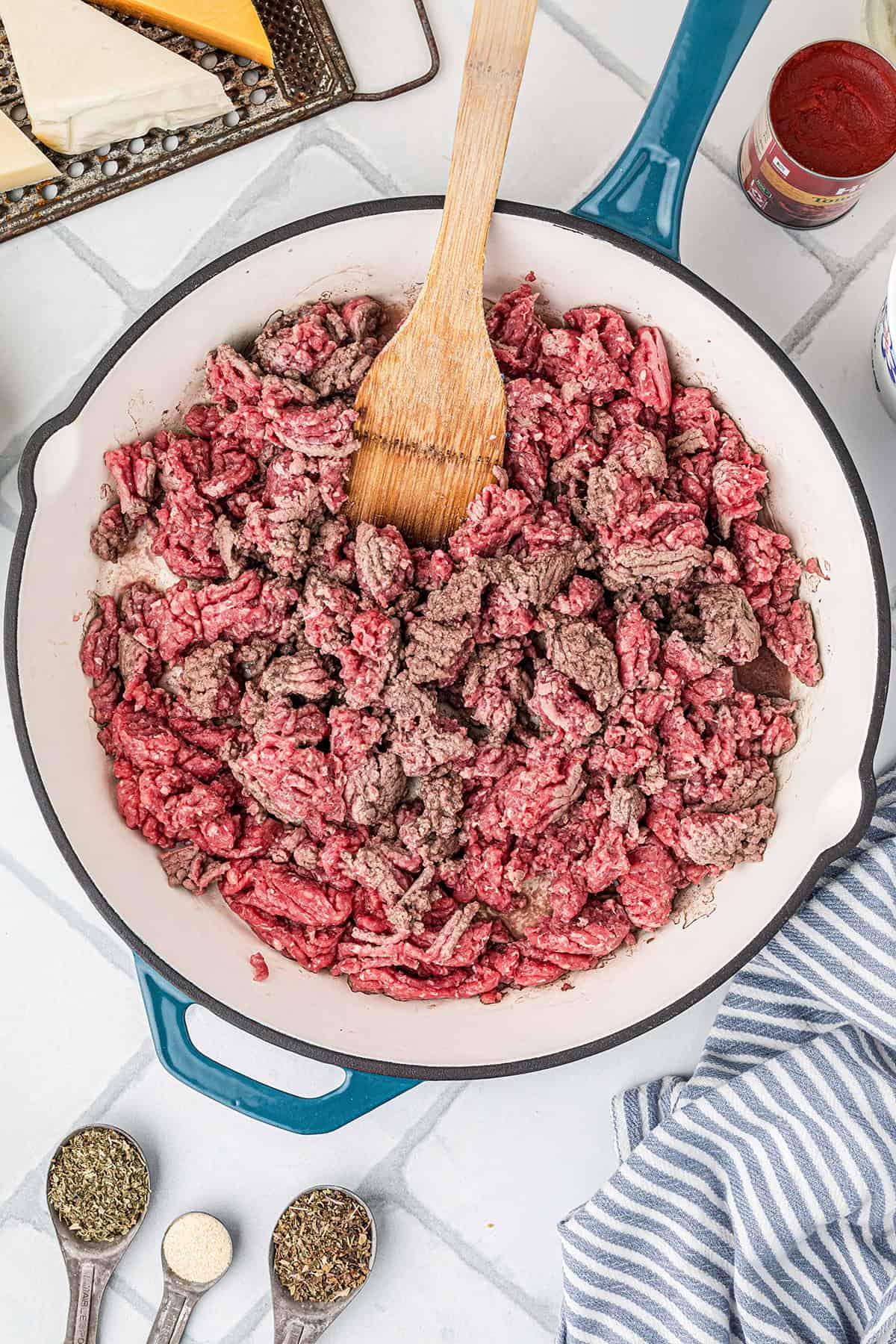 Ground beef browning in a skillet.