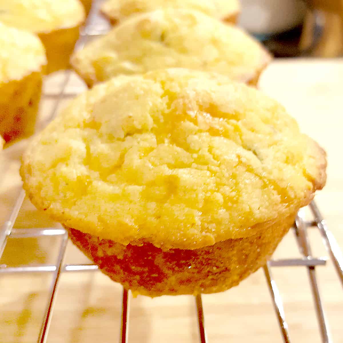 Green Chili Corn Muffins - moist corn muffins packed full of sharp cheddar and green chilis. Perfect with cool weather soups and stews. From NevrEnoughThyme https://www.lanascooking.com/chili-cheese-corn-muffins/