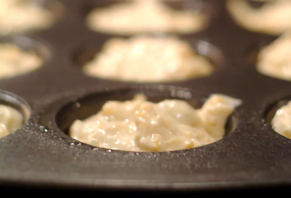 Muffin tin with all cups filled with batter.