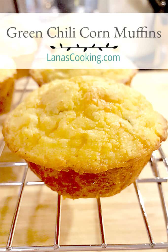 Green Chili Corn Muffins - moist corn muffins packed full of sharp cheddar and green chilis. Perfect with cool weather soups and stews. From NevrEnoughThyme https://www.lanascooking.com/chili-cheese-corn-muffins/