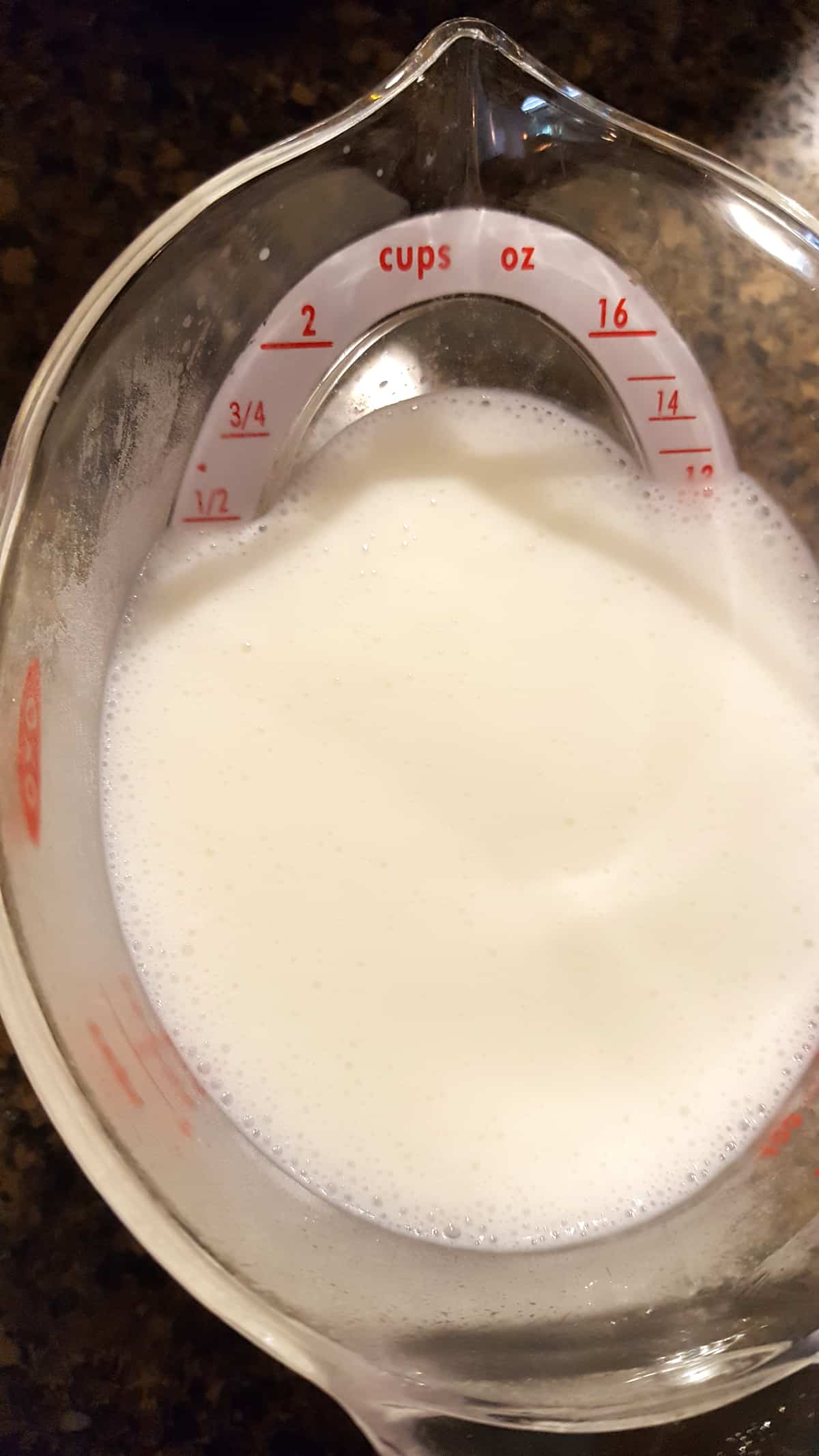 Buttermilk and baking soda in a measuring cup.