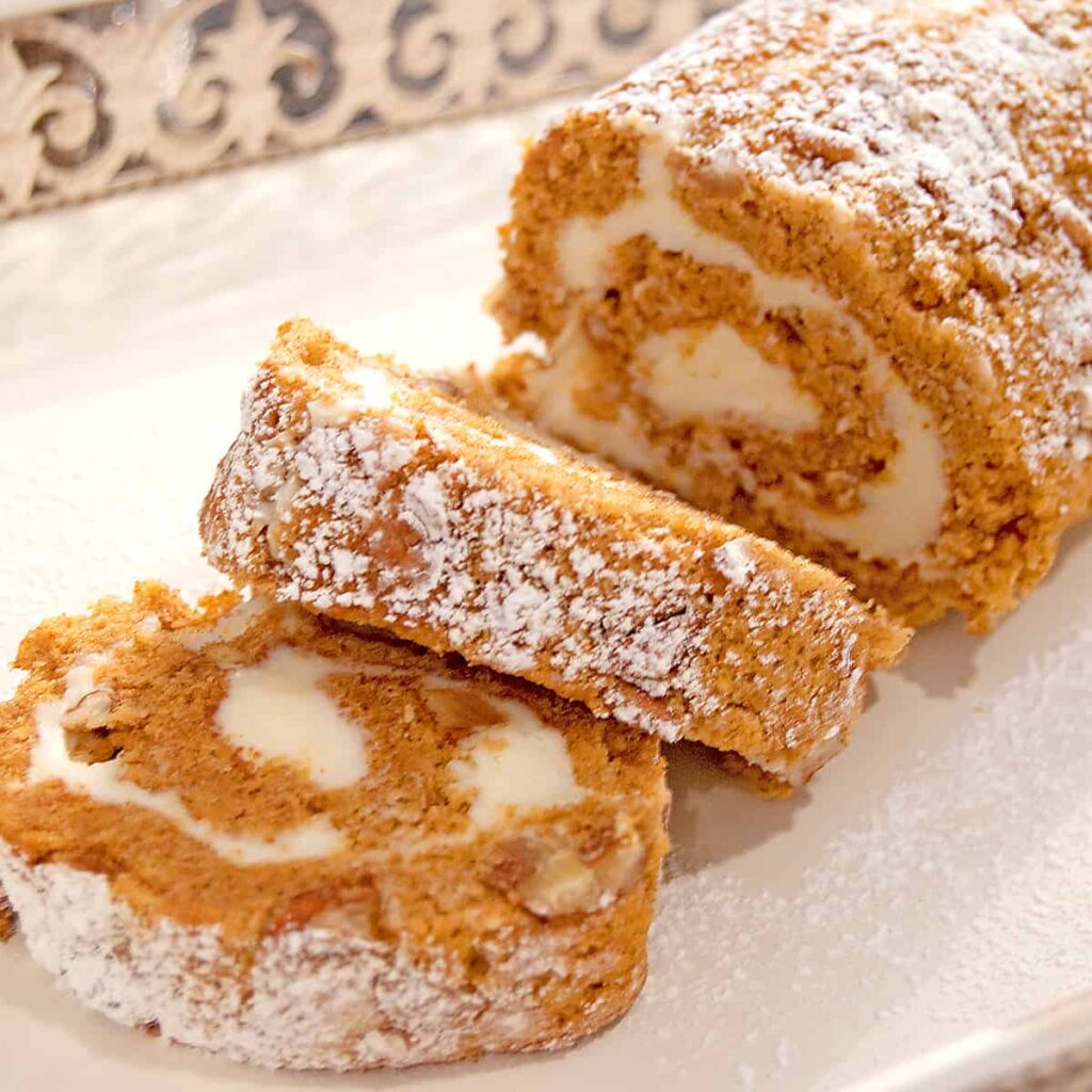 Slices of pumpkin roll on a serving tray.