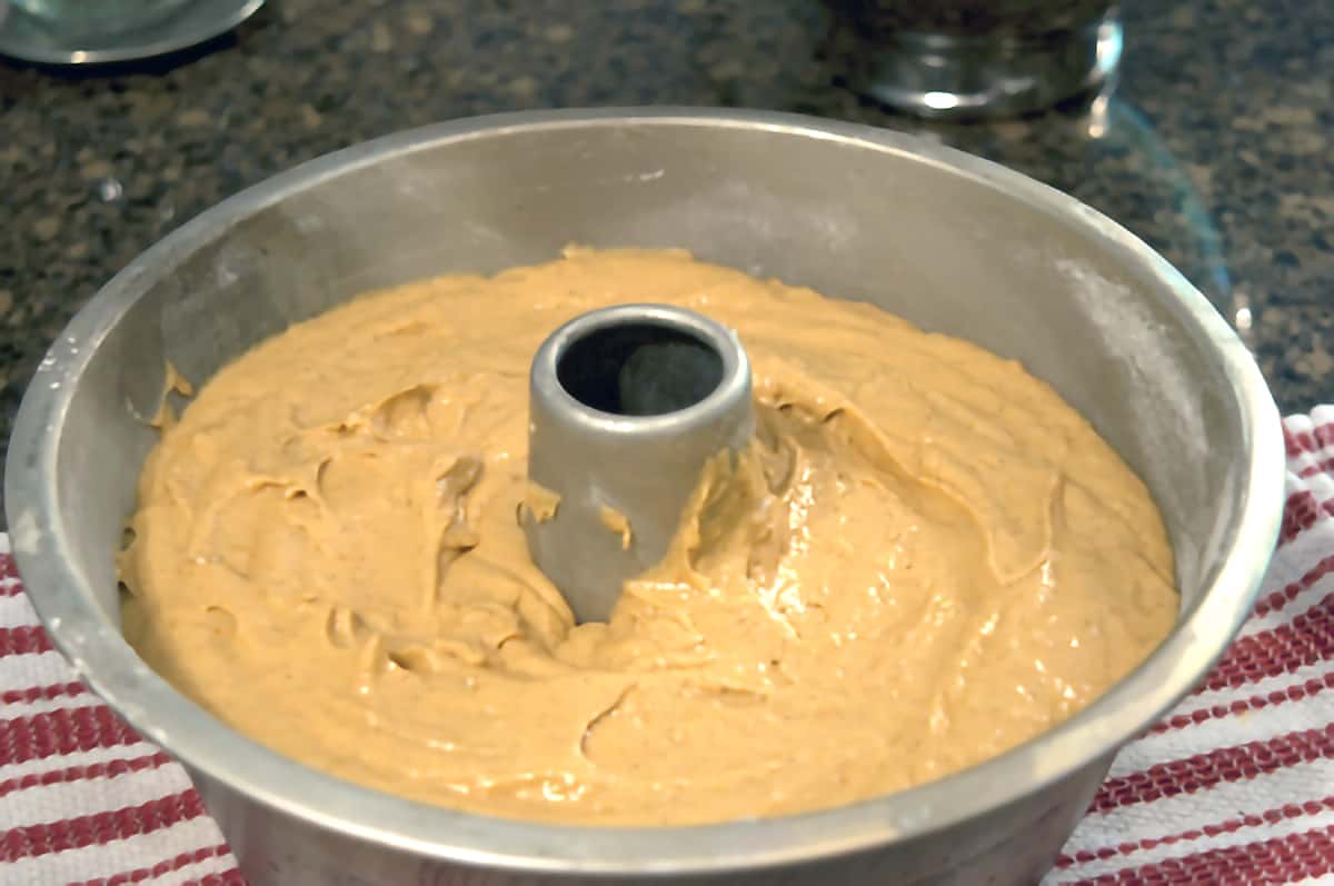Tube pan filled with pumpkin pound cake batter.