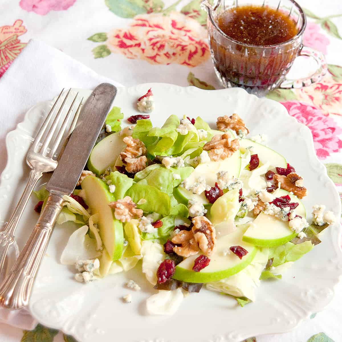 Apple Cranberry Salad on a vintage plate with antique flatware.
