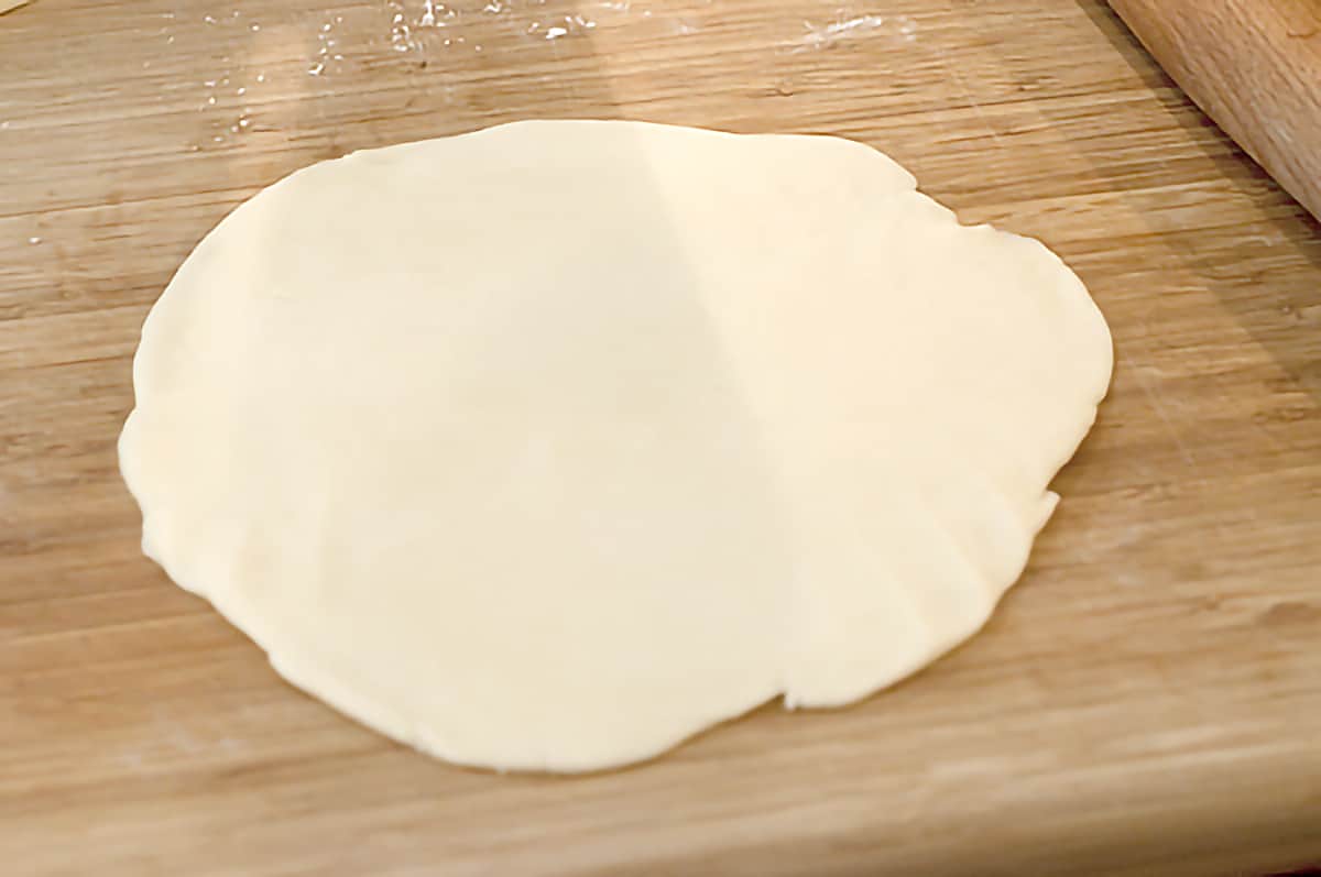 Pie crust on a cutting board.