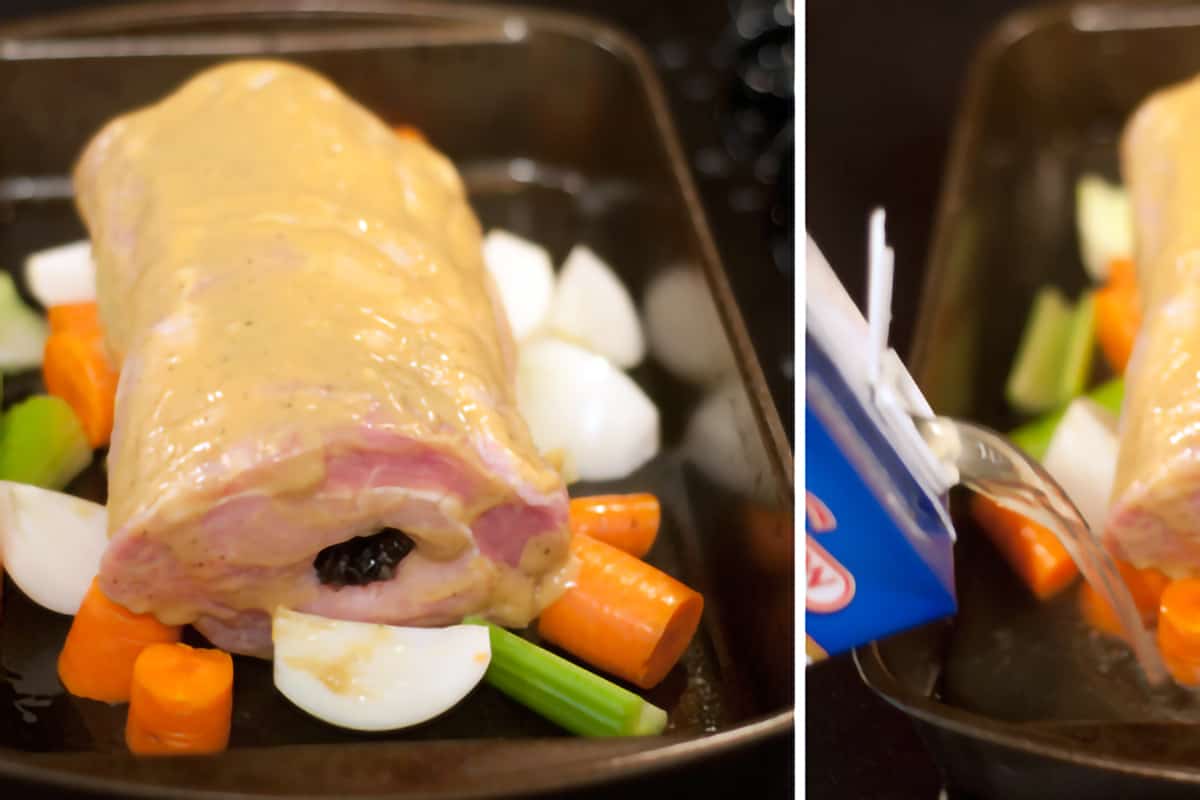 The prepared pork loin resting on top of vegetables in a baking pan.
