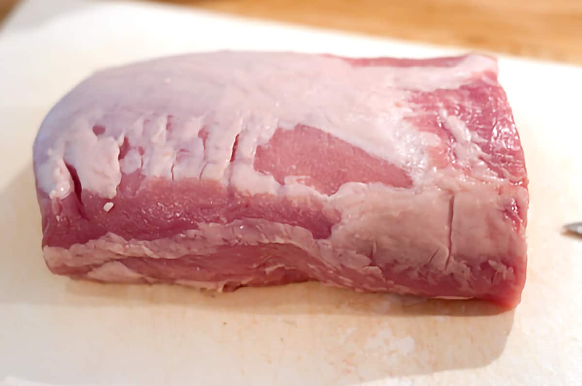 Pork loin sitting on a cutting board