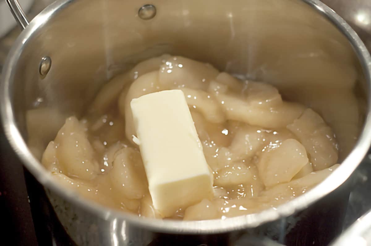 Apple pie filling and butter in a pot.