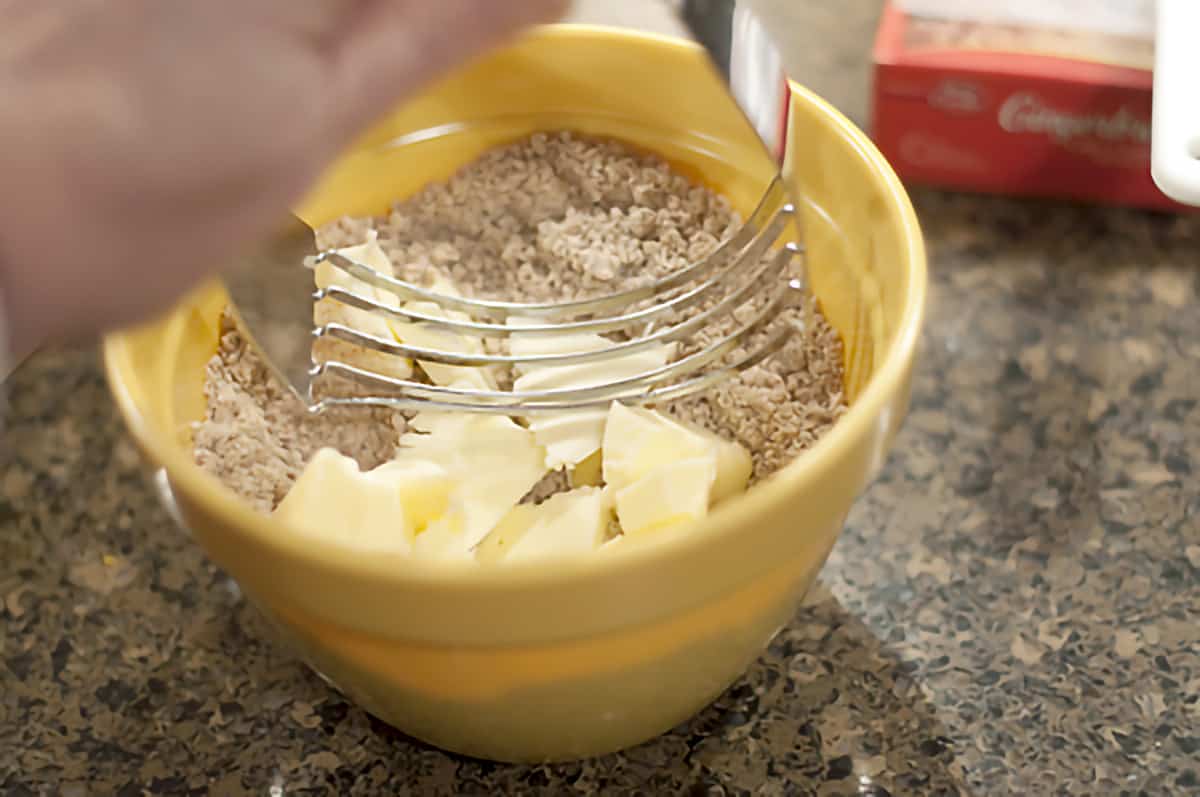 Small mixing bowl with gingerbread mix, brown sugar, and butter.