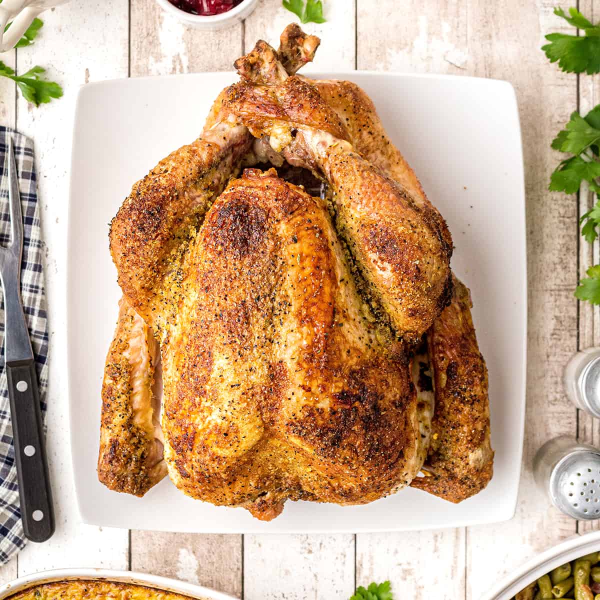 Golden roasted turkey with meat thermometer on table Stock Photo