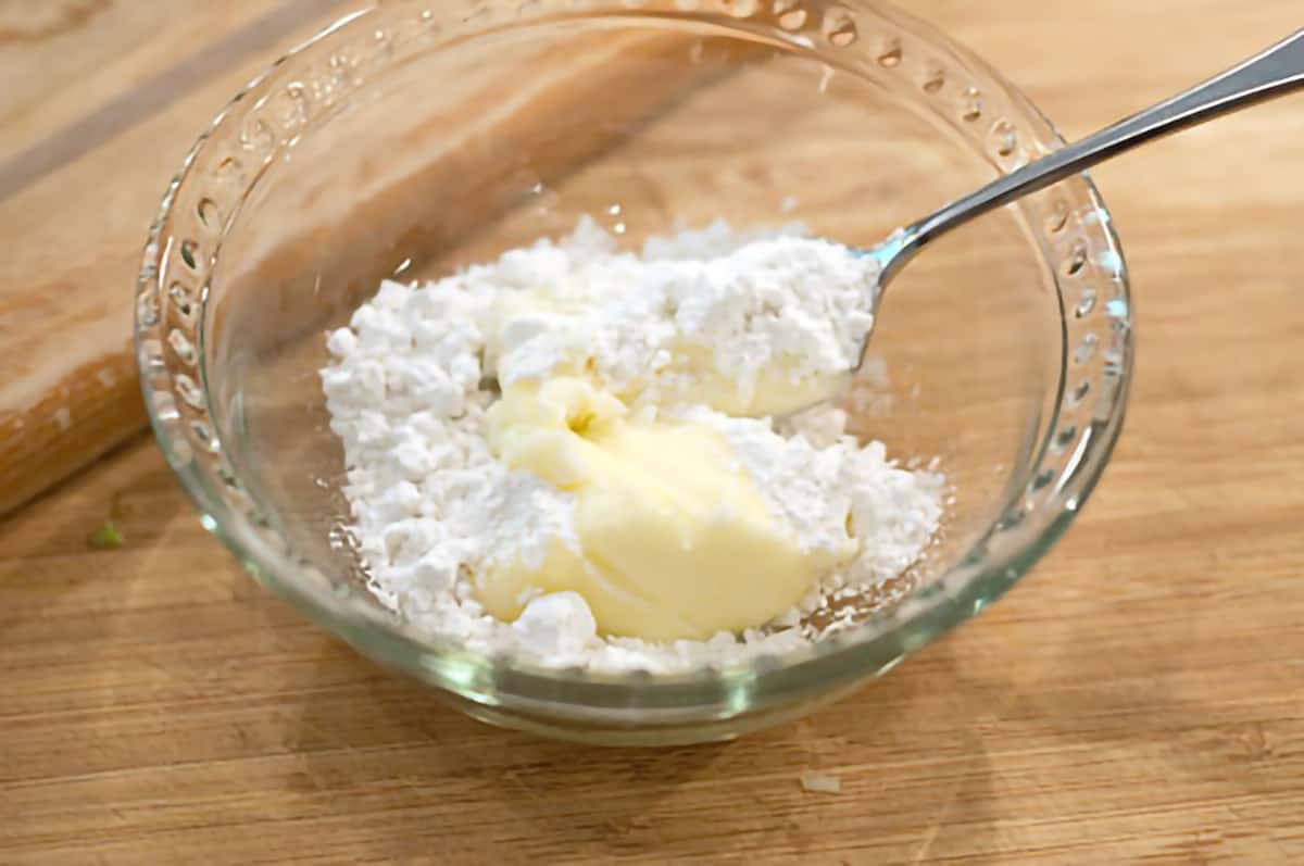 Small bowl containing flour and butter to be combined.