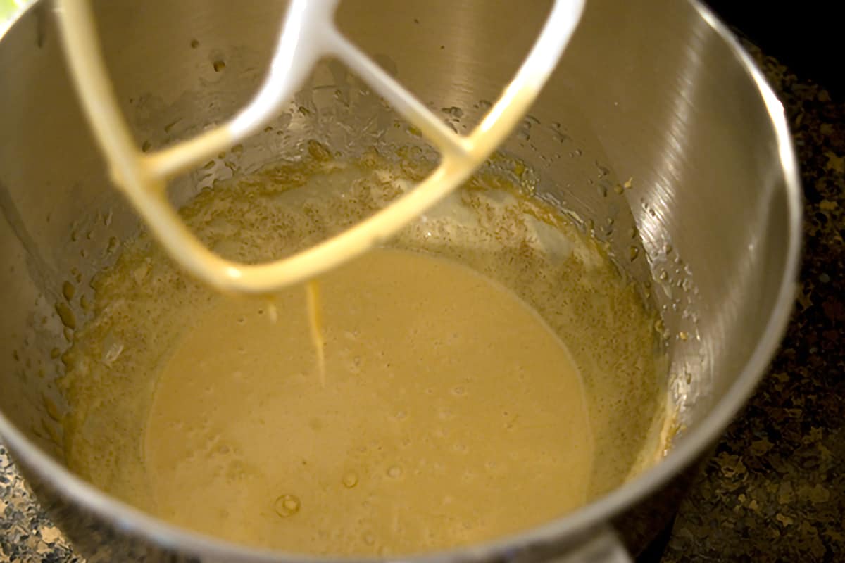 Mixing bowl and beater with butter, sugar, and egg mixture.