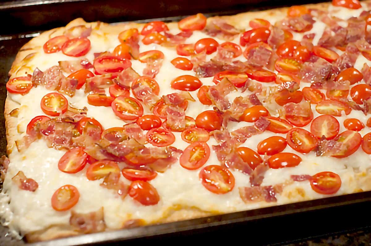 Cooked pizza as it comes out of the oven.