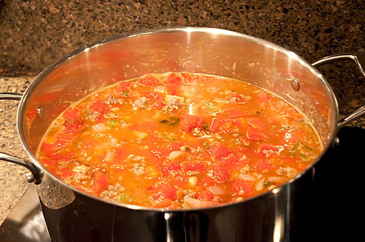 Sausage and vegetable mixture added to stockpot.