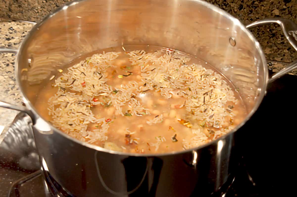 Chicken stock and rice mix in a stockpot.
