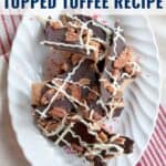 White plate with bacon and pecan topped chocolate toffee pieces, drizzled with white chocolate.