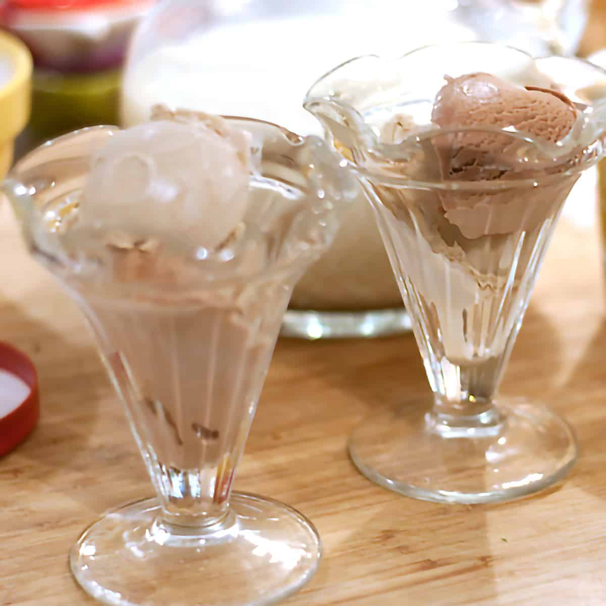 Scoops of ice cream in vintage serving glasses.