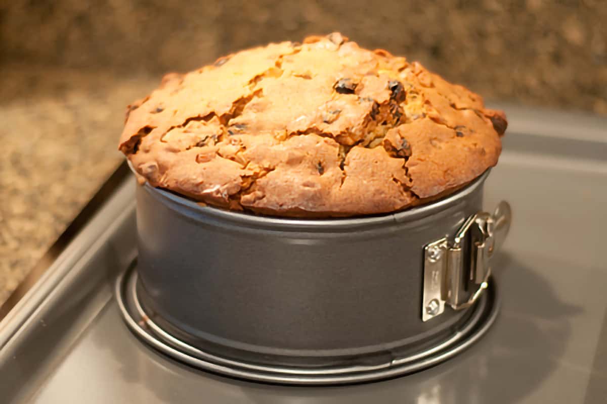 Finished cake in pan sitting on a baking sheet.