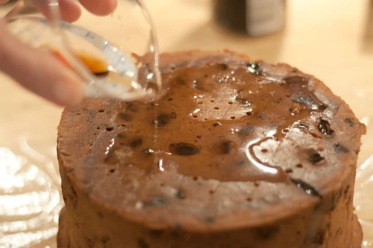 Guinness being poured over the cooled cake.