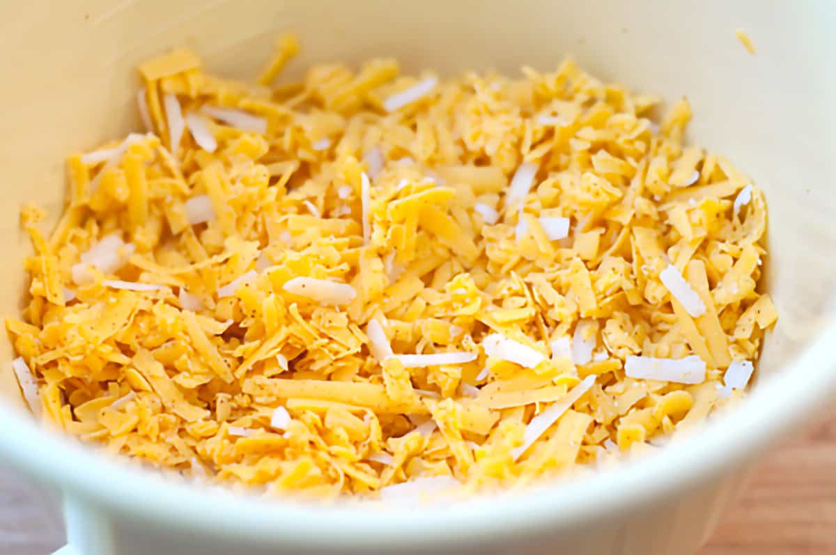 Grated cheese in a mixing bowl.