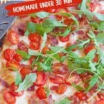 Rectangular BLT pizza topped with cherry tomatoes, bacon, melted cheese, and fresh arugula on a baking tray, with text promoting its quick, homemade preparation.
