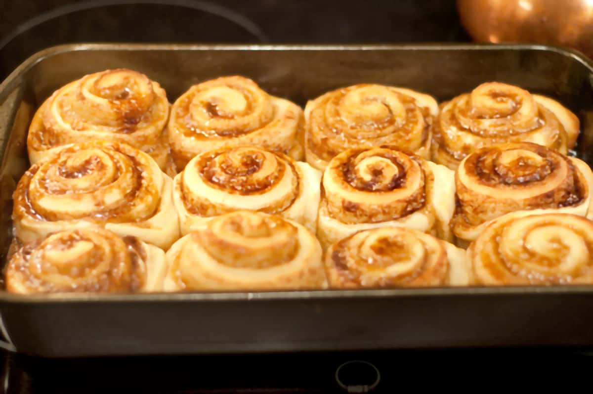 Cinnamon Rolls with Cream Cheese Icing Baking pan with twelve baked cinnamon rolls.