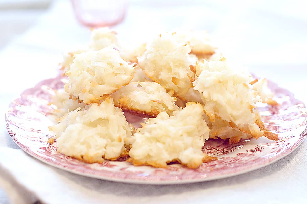 Coconut macaroons on a red and white serving plate.