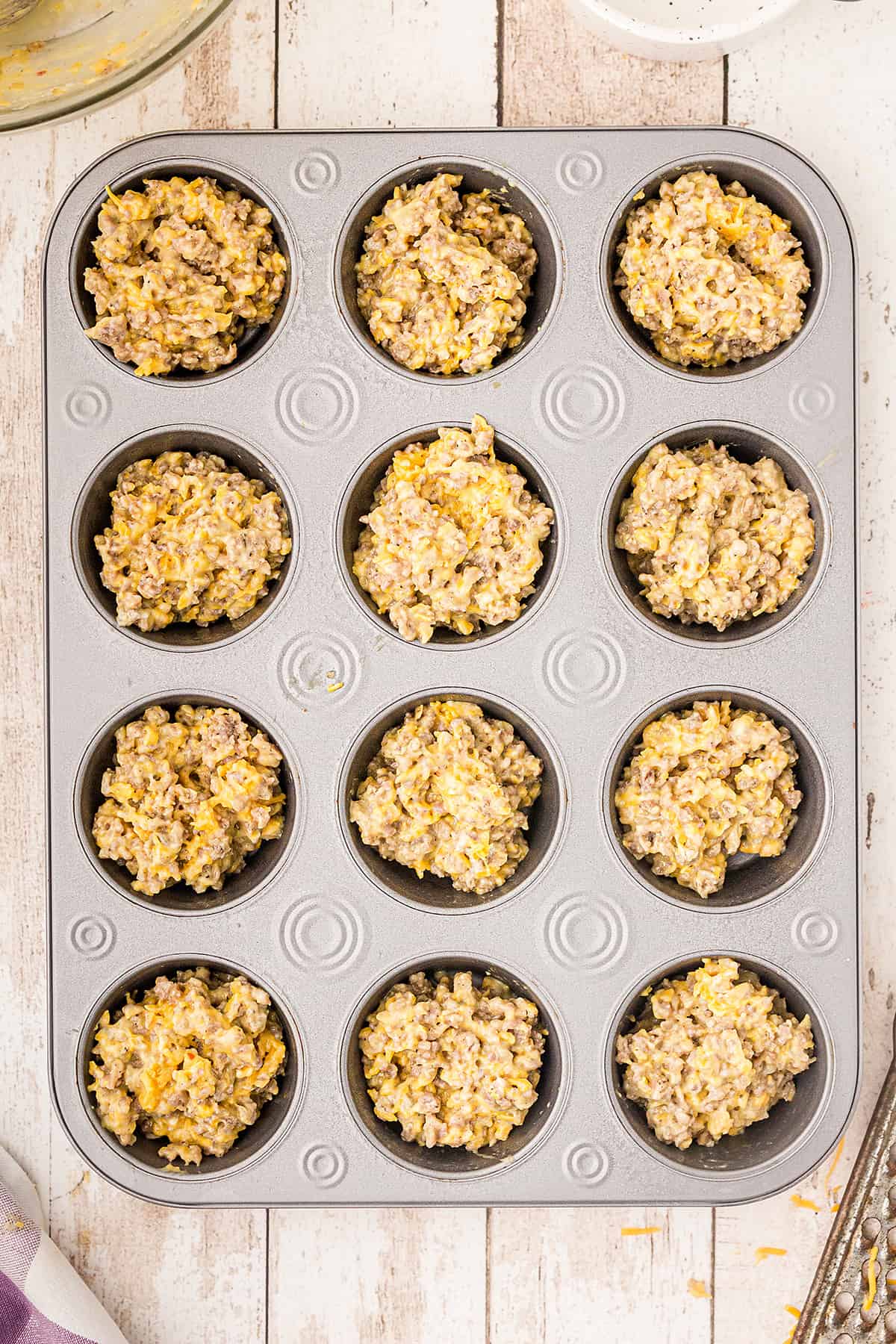 Muffin pan filled with recipe mixture.