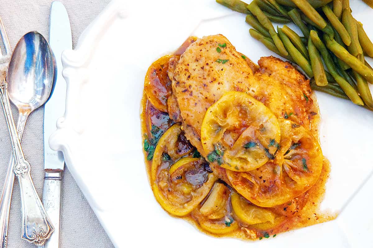 A serving of Meyer Lemon Chicken on a white dinner plate.