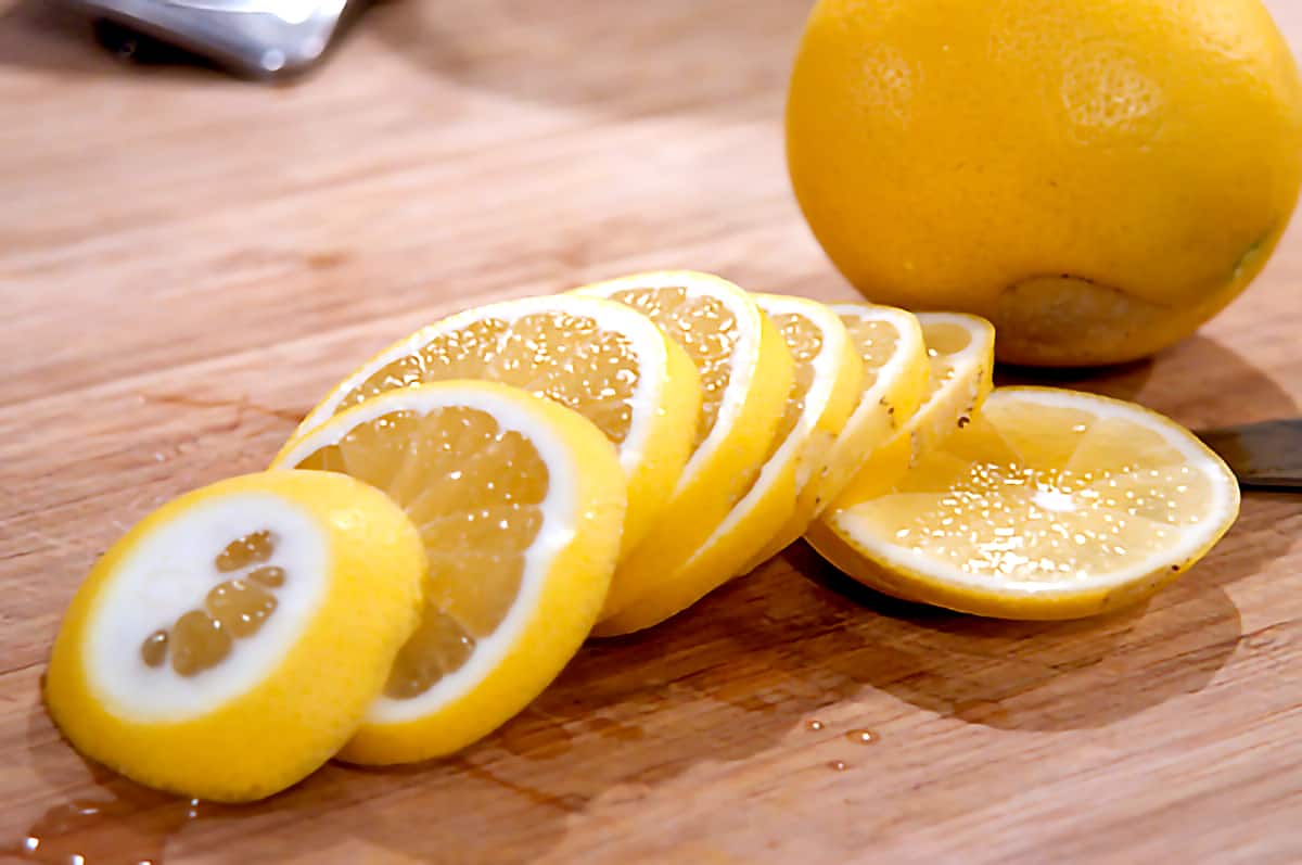 Sliced Meyer lemons Sliced lemons on a cutting board.