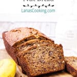 A loaf of Buttermilk Banana Nut Bread sliced and presented on a cutting board.