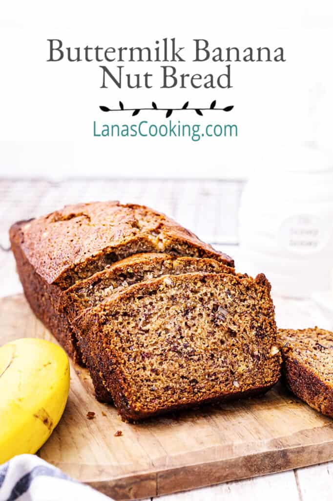 A loaf of Buttermilk Banana Nut Bread sliced and presented on a cutting board.